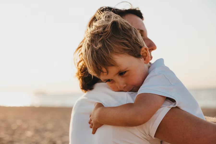 Parent comforting a young child